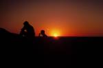 Desert sunset with people